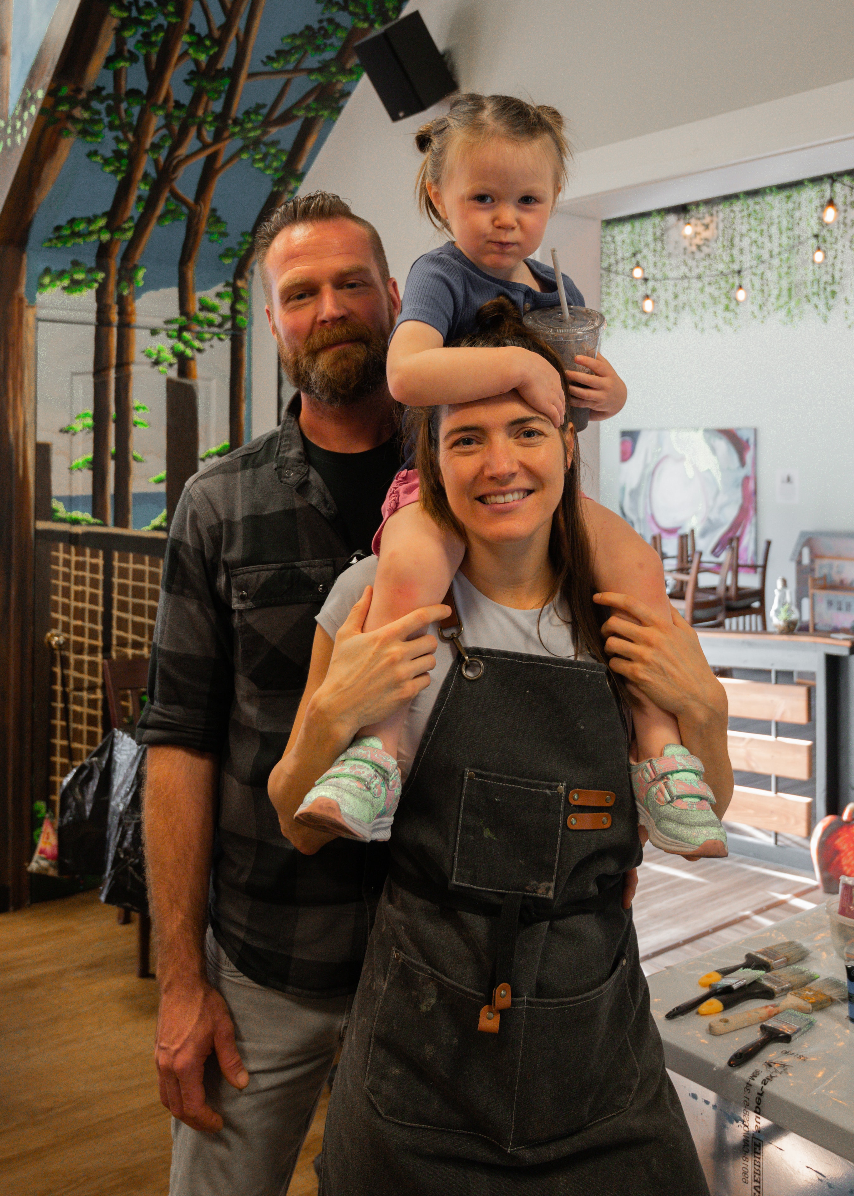 Megan with her husband and daughter inside MegaMindful Living